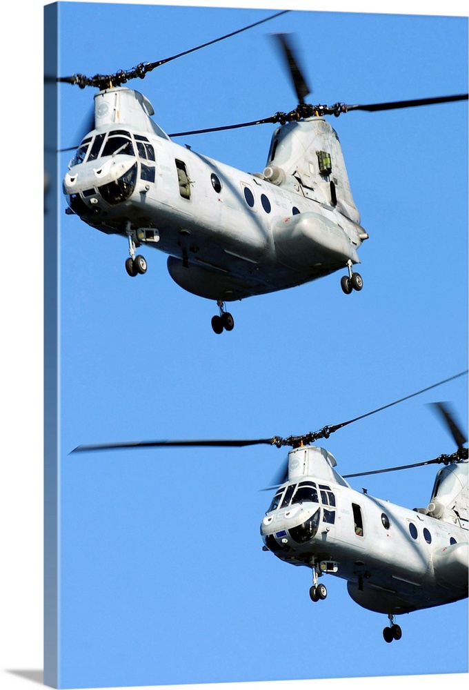 November 9, 2010 - Two U.S. Marine Corps CH-46E Sea Knight helicopters fly near the amphibious assault ship USS Boxer, pri...