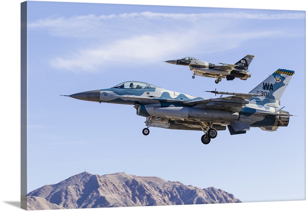 Two U.S. Air Force F-16 Fighting Falcon aggressor aircraft on final approach.