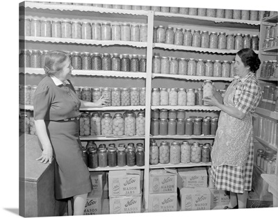 Two women standing in a kitchen pantry, circa 1946