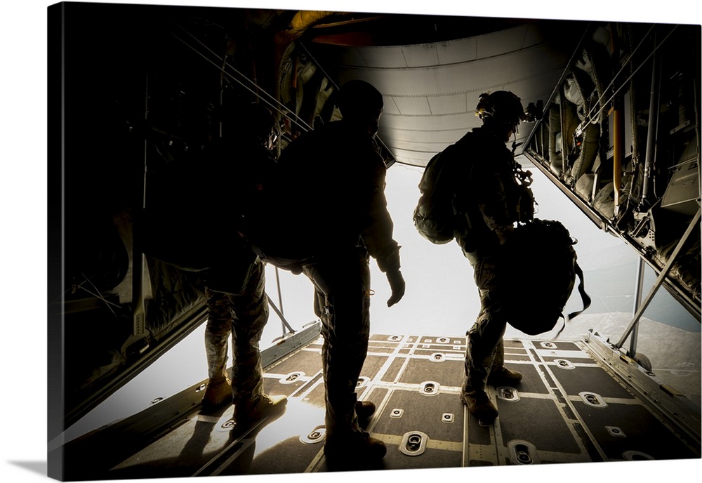 U.S. Army Green Berets wait to jump out of a C-130H3 Hercules.