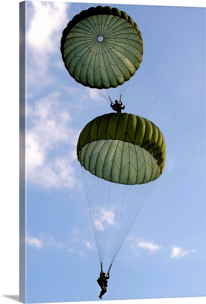 U.S. Army Soldiers parachute down after jumping from a C 130 Hercules ...