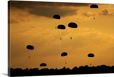 U.S. Army Soldiers parachute through the sky