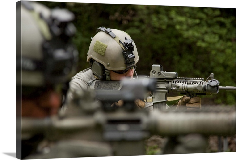 U.S. Special Forces soldiers provide security with automatic rifles.