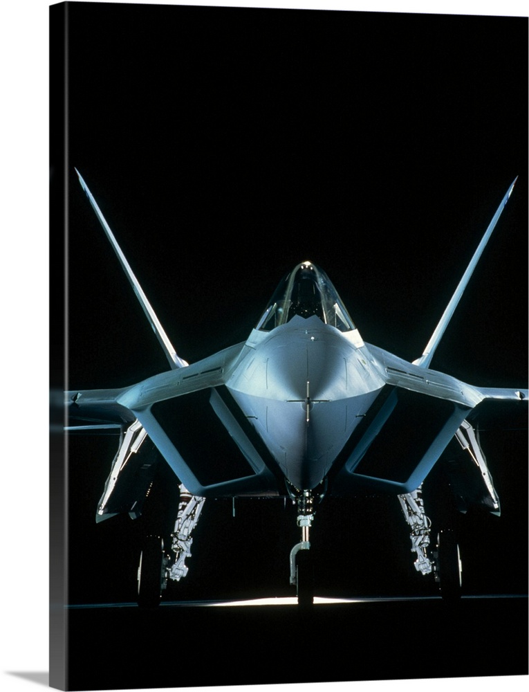 Vertical photograph on a big canvas of a front view of a United States Military Aircraft, on a solid black background.
