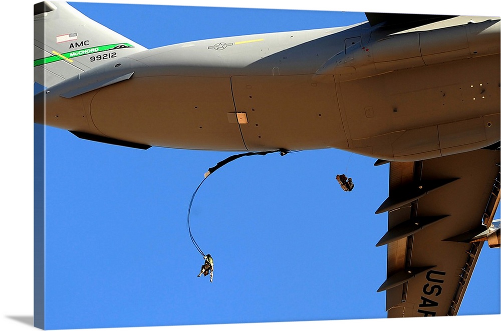 U.S Air Force Airmen parachute into a drop zone from a C-17 Globemaster III.