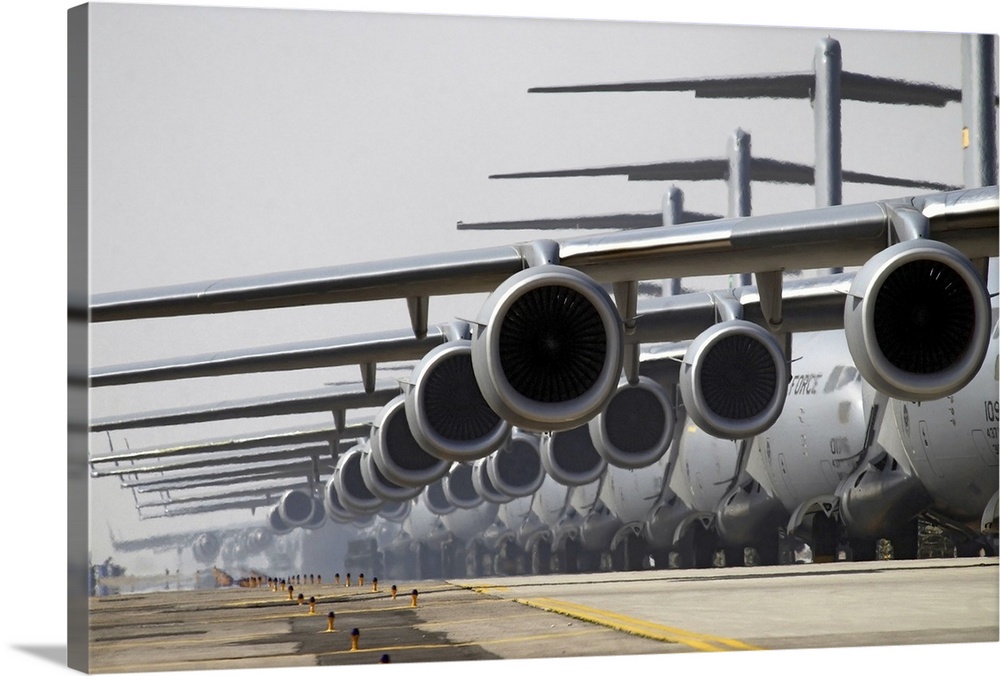 Military phograph looking down a runway at a fleet of C17 US Air Force planes lined up ready for take off.