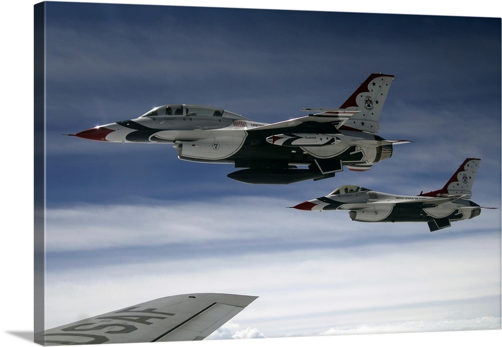 U.S. Air Force F-16 aircraft fly off the wing of a KC-135 Stratotanker.