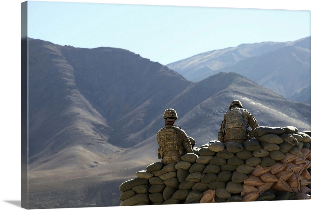 U.S. Army soldiers run communications equipment from a sandbag bunker in Afghanistan.
