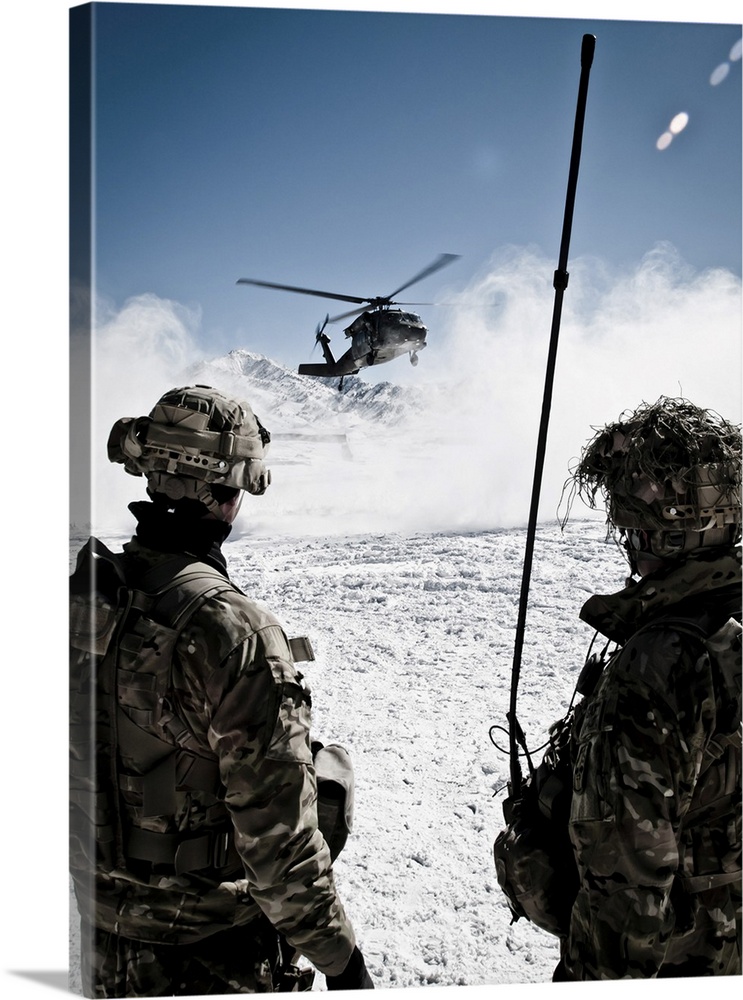 U.S. Army soldiers watch the arrival of a helicopter at their remote combat outpost in Marzak, Afghanistan. Marzak has bee...