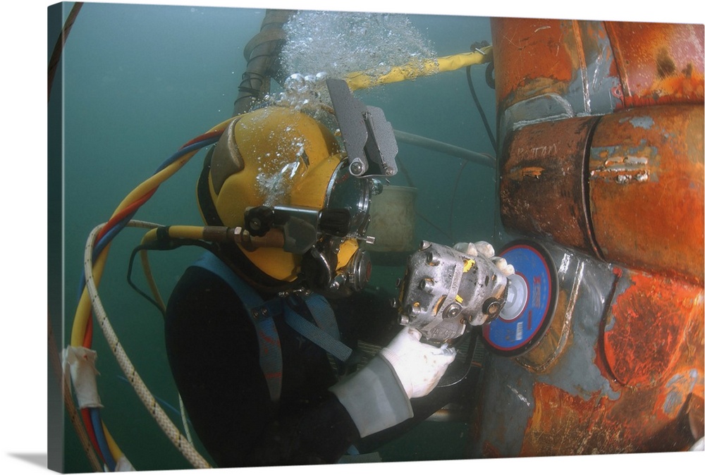 January 4, 2007 - U.S. Navy Diver uses a grinder to file down a repair patch on the submerged bow of the USS Ogden (LPD-5)...