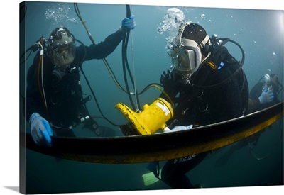 US Navy Diver Instructs A Barbados Coast Guard Diver On Using A Hydraulic Grinder