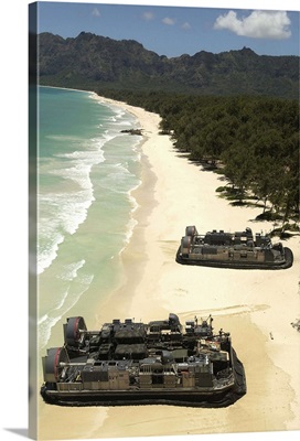 US Navy Landing Craft land on the beach to offload equipment in Oahu Hawaii