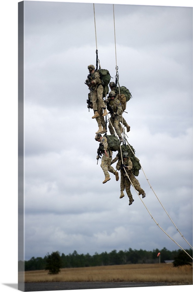 U.S. Soldiers are lifted off the ground by a CH-47 Chinook helicopter.
