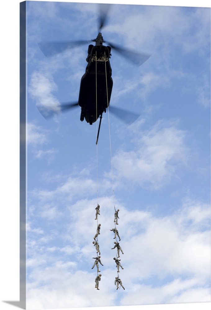 U.S. Soldiers are suspended by a CH-47 Chinook helicopter.