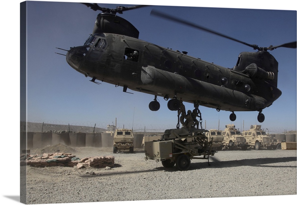 October 2, 2011 - U.S. soldiers attach sling load ropes to an Army CH-47 Chinook helicopter at Combat Outpost Sar Howza in...