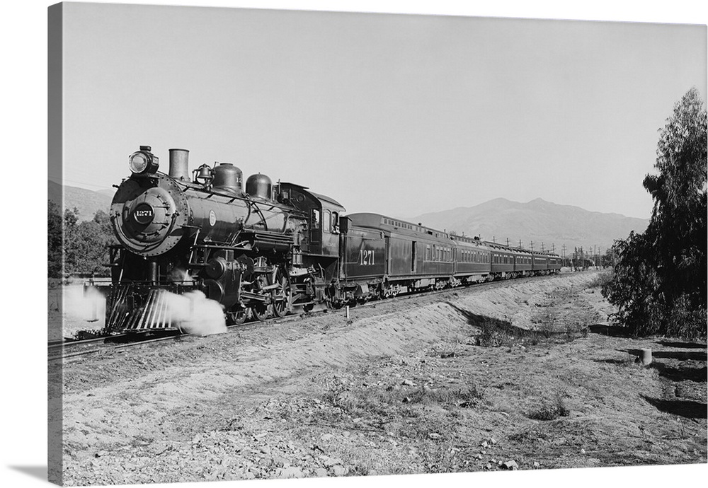 Vintage photo of a passenger train speeding down the tracks.