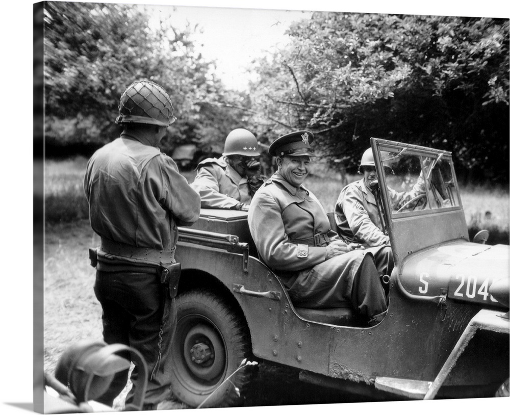 Vintage World War II photo of General Dwight D. Eisenhower sitting in a jeep talking with other officers.