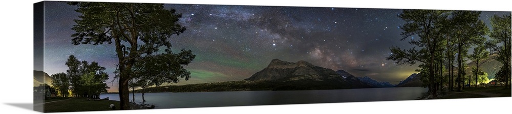 Nightscape panorama of Waterton Lakeshore in Canada, with Milky Way rising above mountain