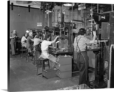 Women drill press operators working in a west coast airplane factory, circa 1942