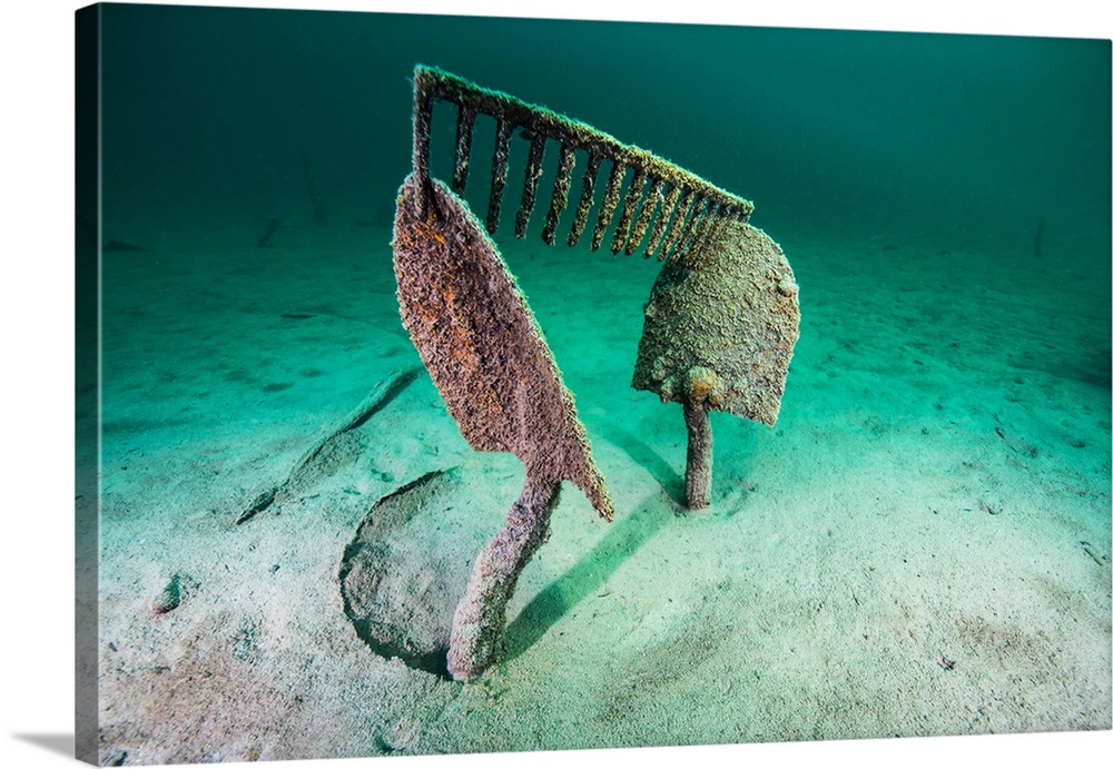 Work tools buried in the sand of Lake McDonald, Montana.