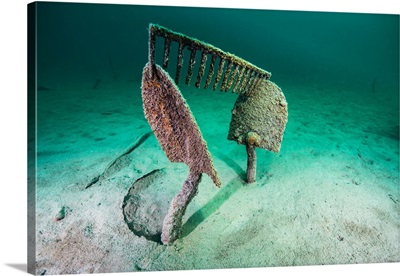 Work tools buried in the sand of Lake McDonald, Montana