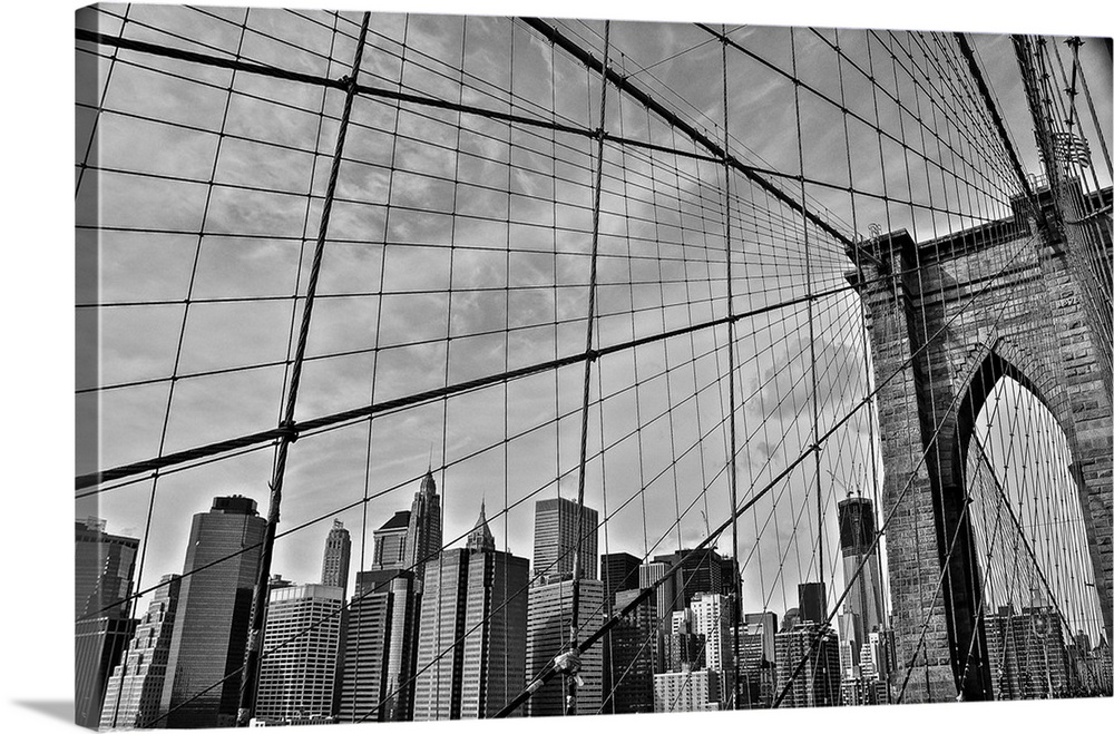 View of the cables from the Brooklyn Bridge with the New York City skyline in the distance.