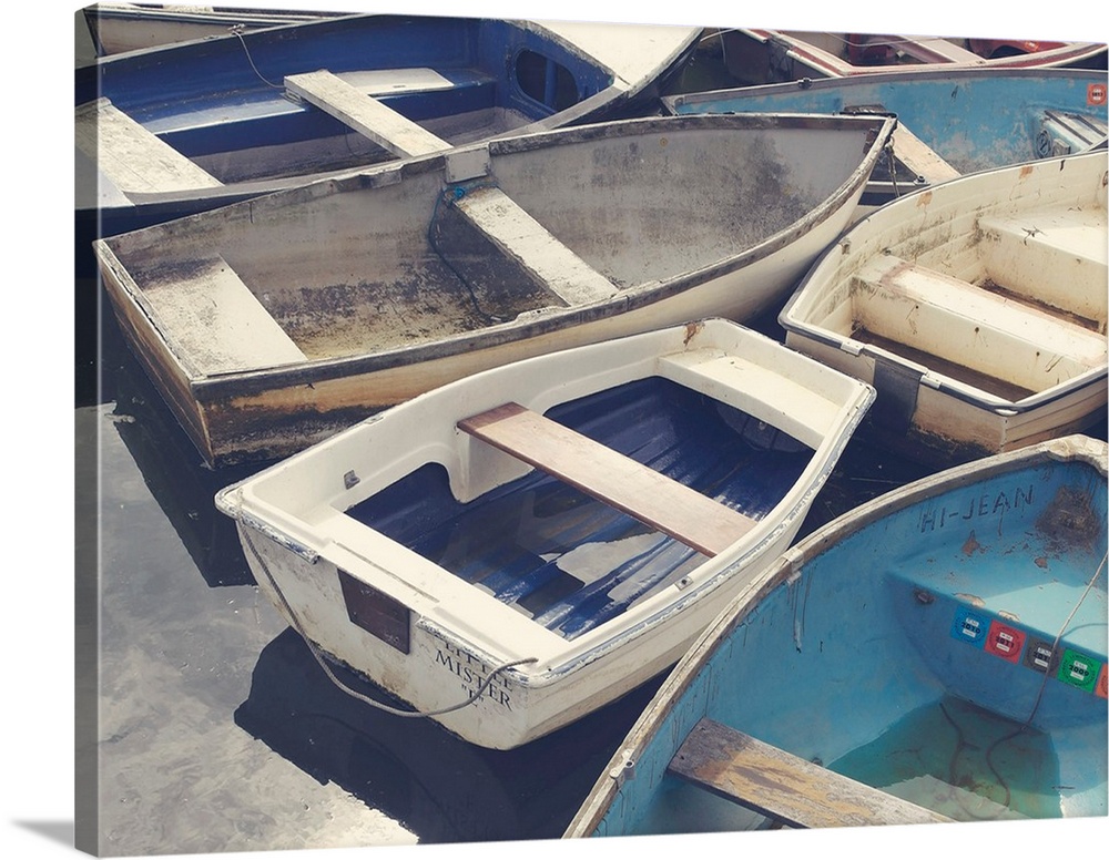 A photograph of a cluster of worn boats.