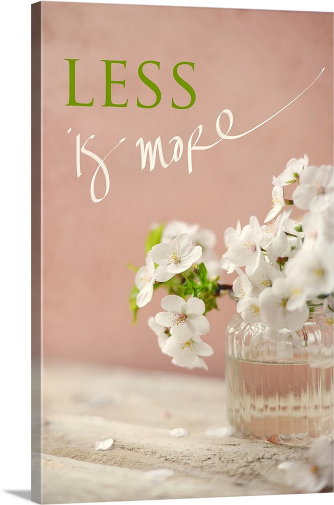 Photograph of a white floral arrangement in a glass vase with the phrase "Less is More" written at the top in green and wh...