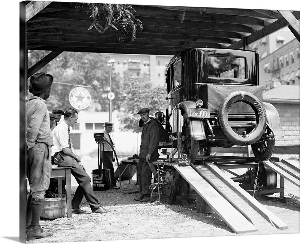 A car being inspected at an American gas station, 1924.