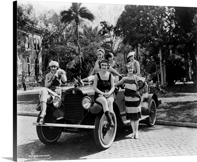 A group of Bathing Beauties posing with a Columbia Six Sport Automobile, 1920