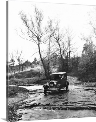 A Model A Ford crossing a creek bed in Oldham County, Kentucky, 1930