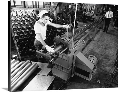 A worker at a tube cutting machine in a factory in Louisville, Kentucky, 1945