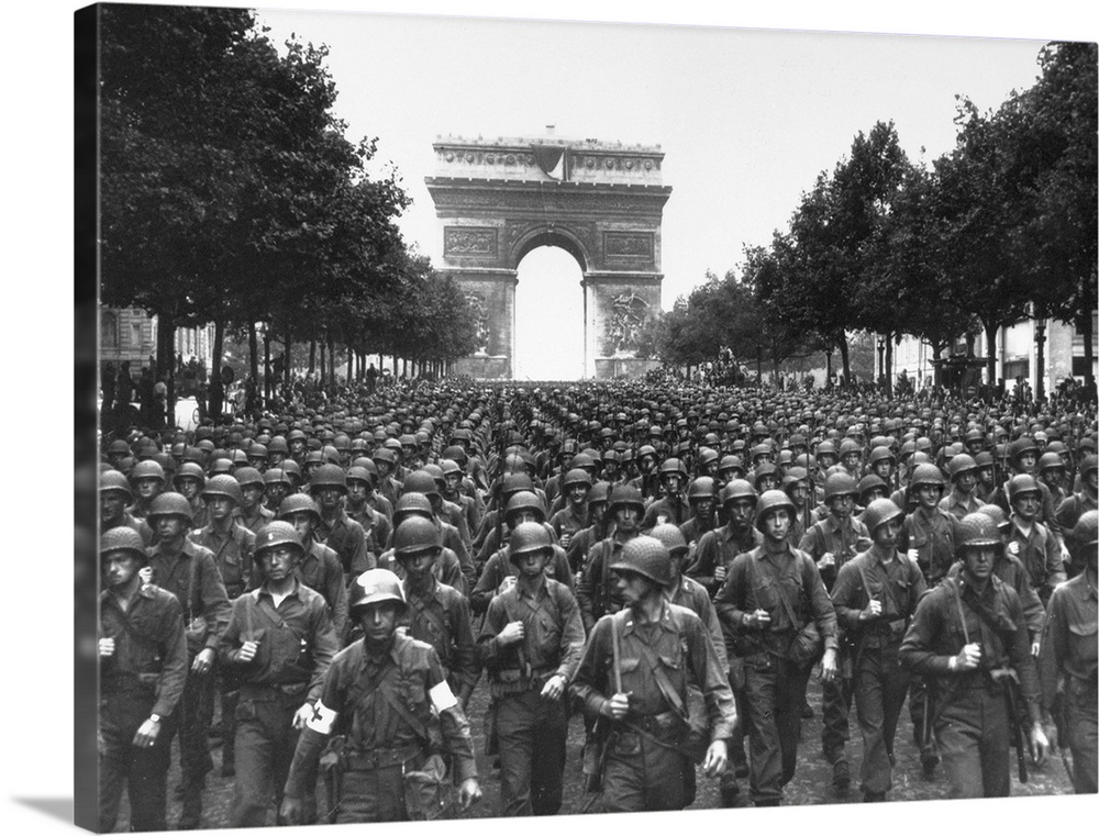 American troops marching on the Avenue des Champs-?lys?es in Paris, France, with the Arc de Triomphe in the background. Ph...