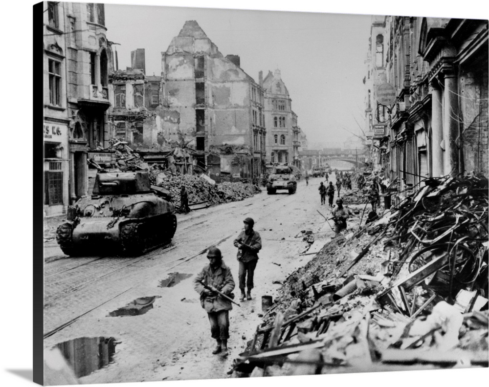 American troops on patrol through the ruins of Cologne, Germany. Photograph, 1945.