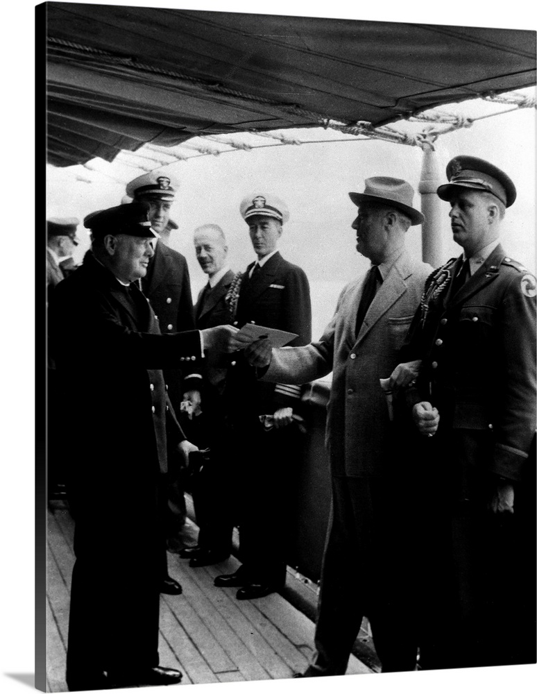 Prime Minister Winston Churchill and President Franklin D. Roosevelt (exchanging document) aboard the HMS 'Prince of Wales...
