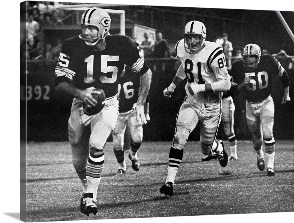 Quarterback Bart Starr of the Green Bay Packers attempting to run for a first down against the Baltimore Colts after faili...