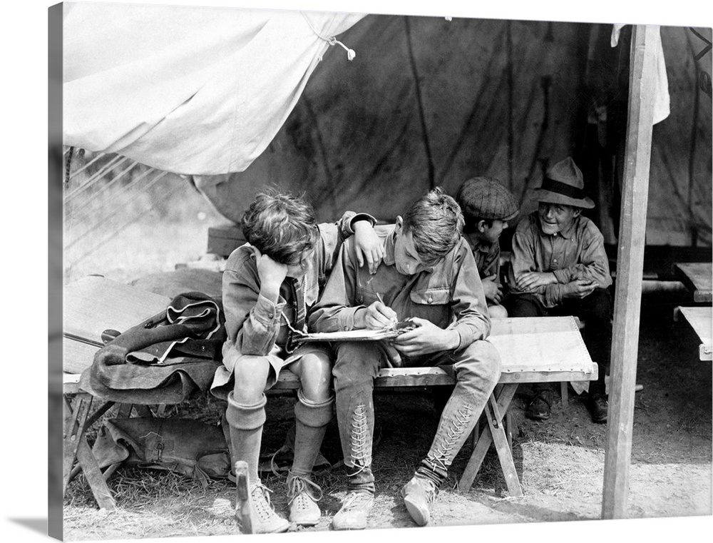 Boy Scouts writing letters home from camp at Hunter Island, in Pelham Bay Park, New York City. Photograph, c1912.