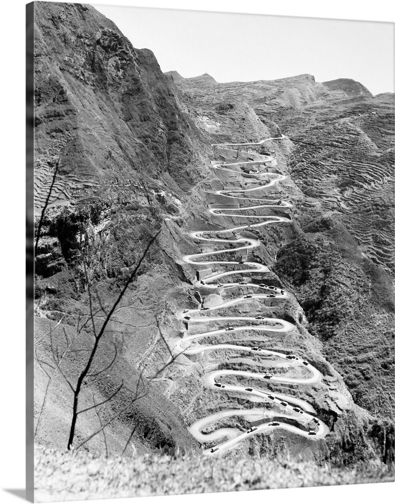 A U.S. military convoy drives on the switchbacks of Ledo Road at Annan, China, during World War II. Photographed 26 March ...