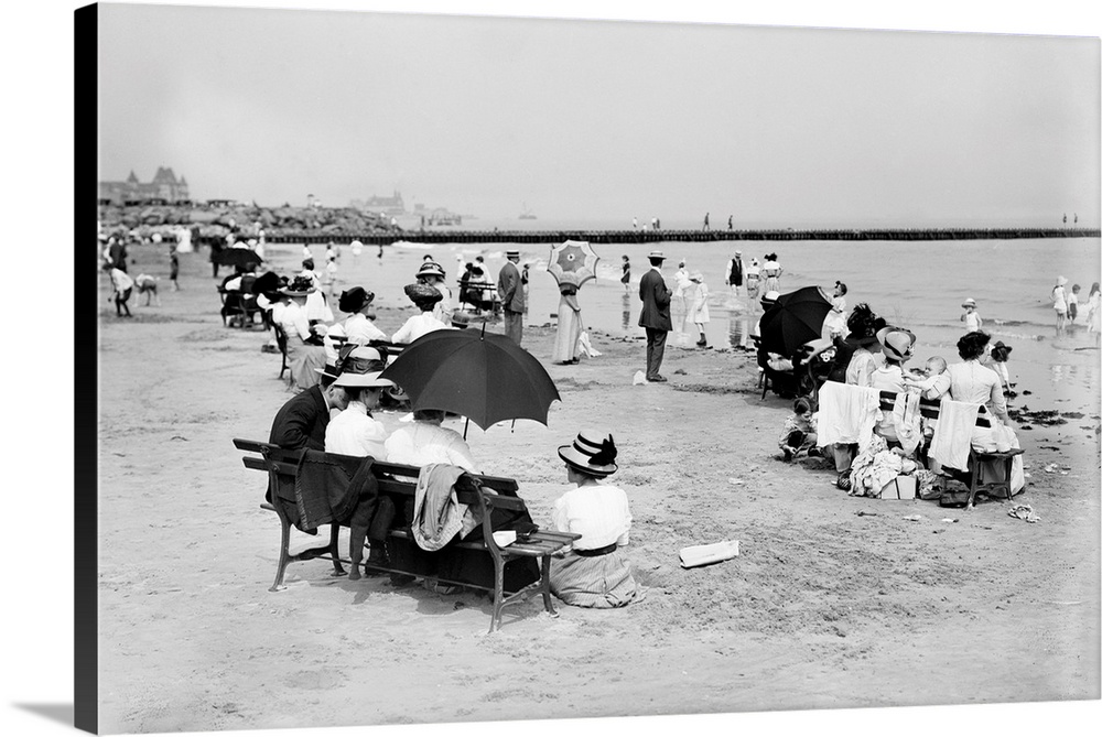 People seated on park benches by the seashore at Coney Island, Brooklyn, New York. Photograph, c1910.