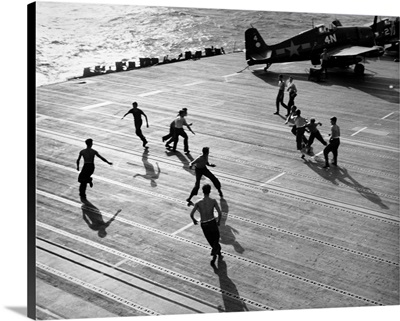 Crew of the aircraft carrier USS Hornet, playing touch football on the flight deck