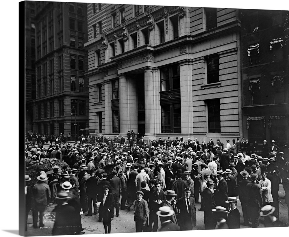 Crowd of men involved in curb exchange trading on Broad Street in New York City. Photograph, c1906.