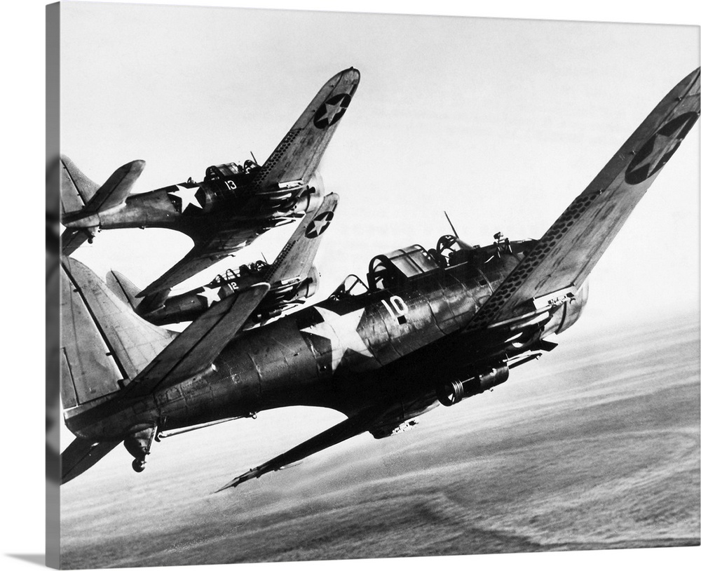 Three U.S. Navy Douglas SBD 'Dauntless' dive bombers flying over the Pacific Ocean