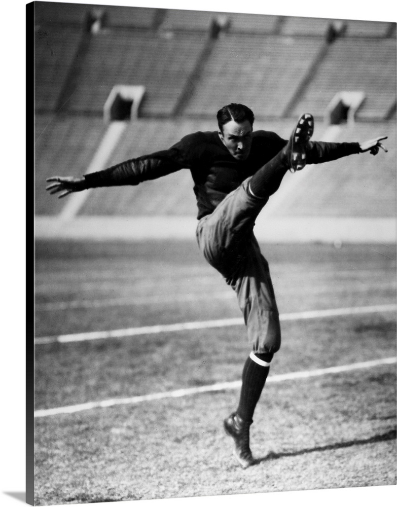 An unidentified American football player kicking the ball, early 20th century.