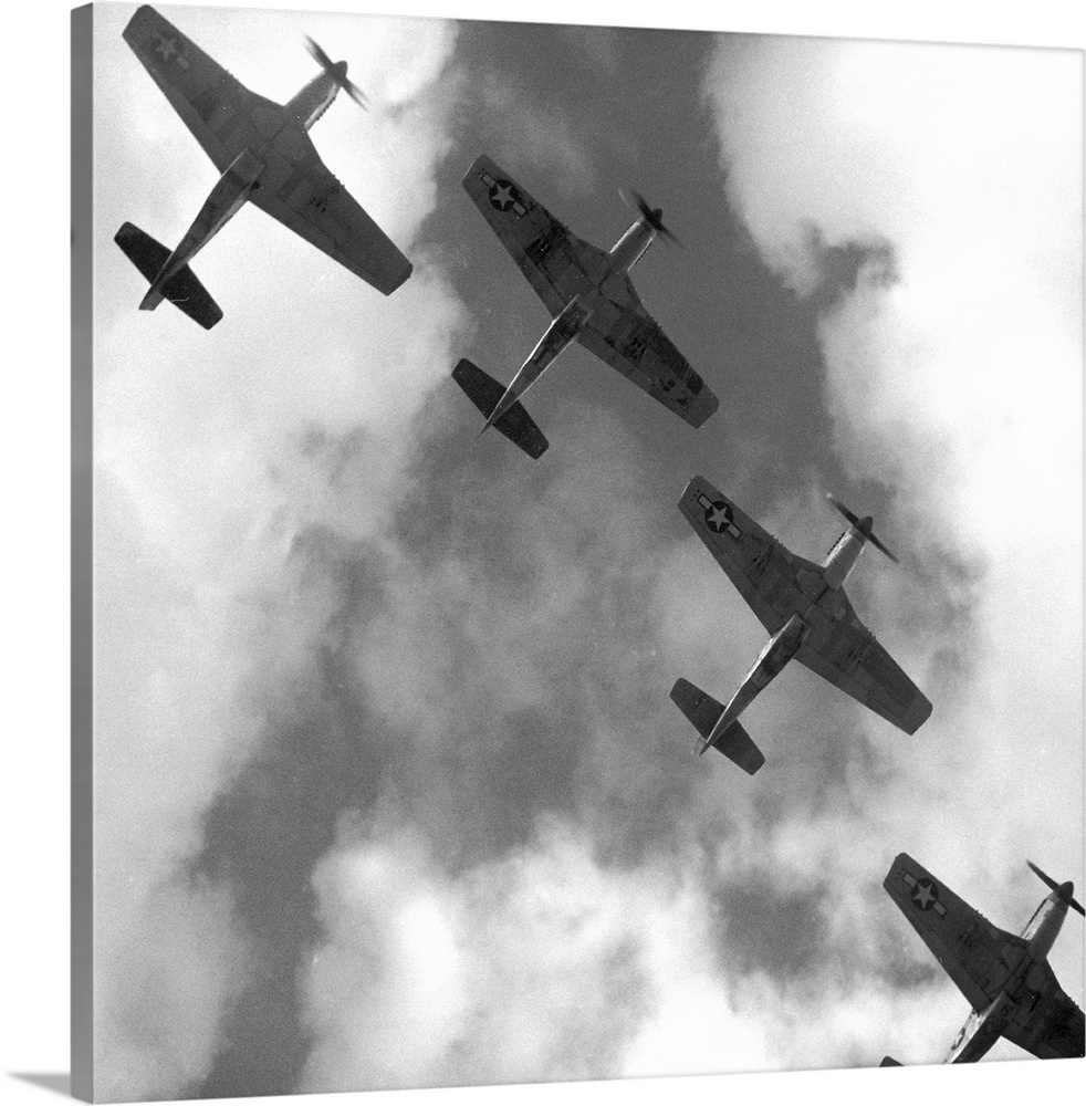 Four P-51 Mustang fighter planes flying in formation over Ramitelli, Italy. Photograph by Toni Frissell, March 1945