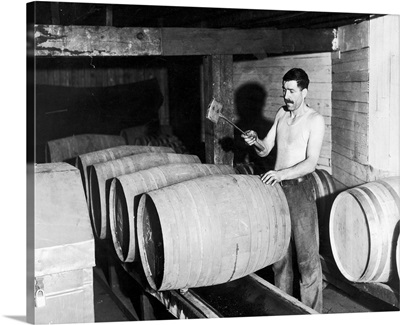 In preparation for the repeal of prohibition, a worker empties barrels, 1933
