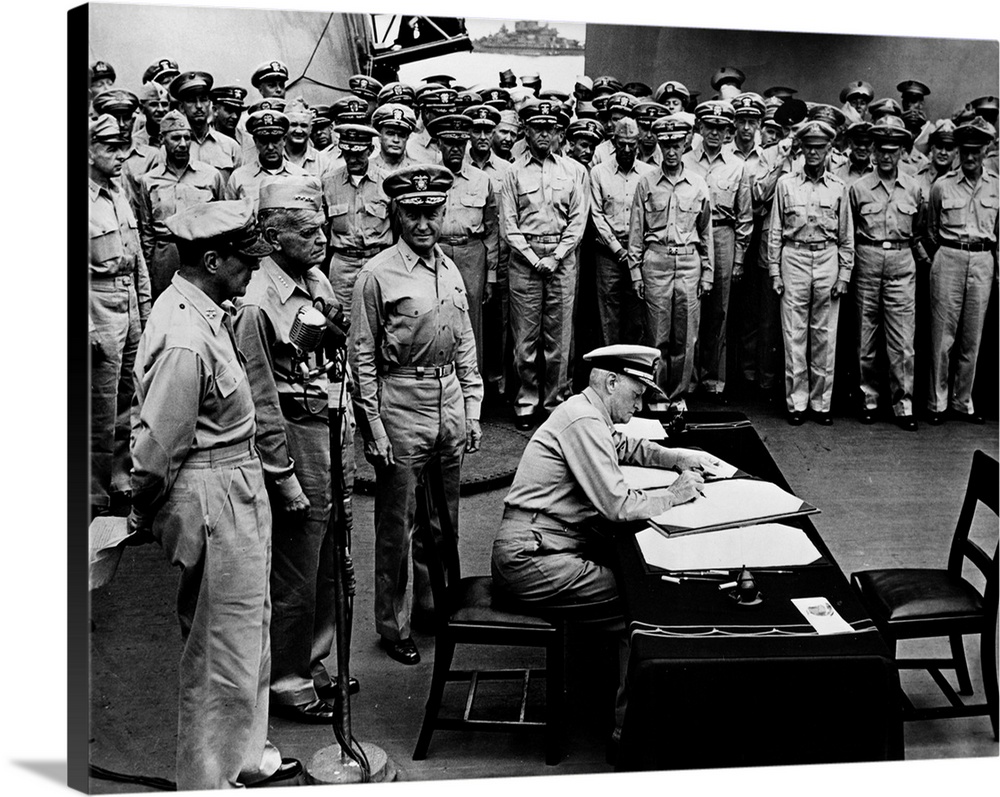 U.S. Admiral Chester W. Nimitz signs the official instrument of Japan's surrender to the Allied forces on board the U.S.S....