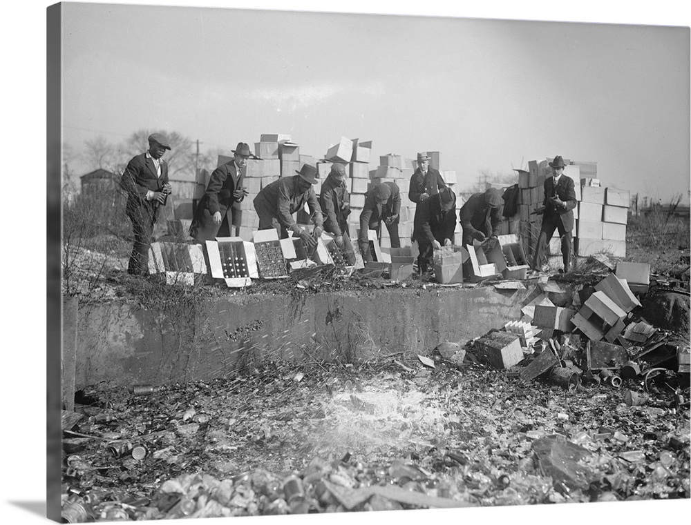 Group of men destroying bootleg liquor and beer during Prohibition in America. Photograph, 20 November 1923.