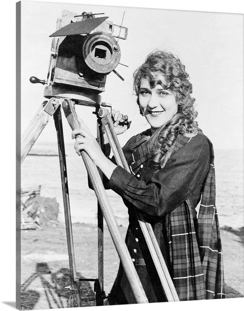 Born Gladys Mary Smith. American actress, with a movie camera on a beach, c1916.