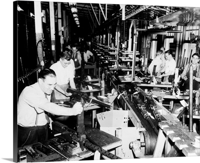 Men working on machine guns at the General Motors plant in Detroit, Michigan