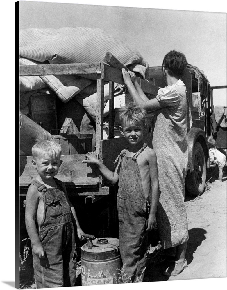 Part of an impoverished homeless family of nine on a New Mexico highway, preparing to sell their belongings for money to b...